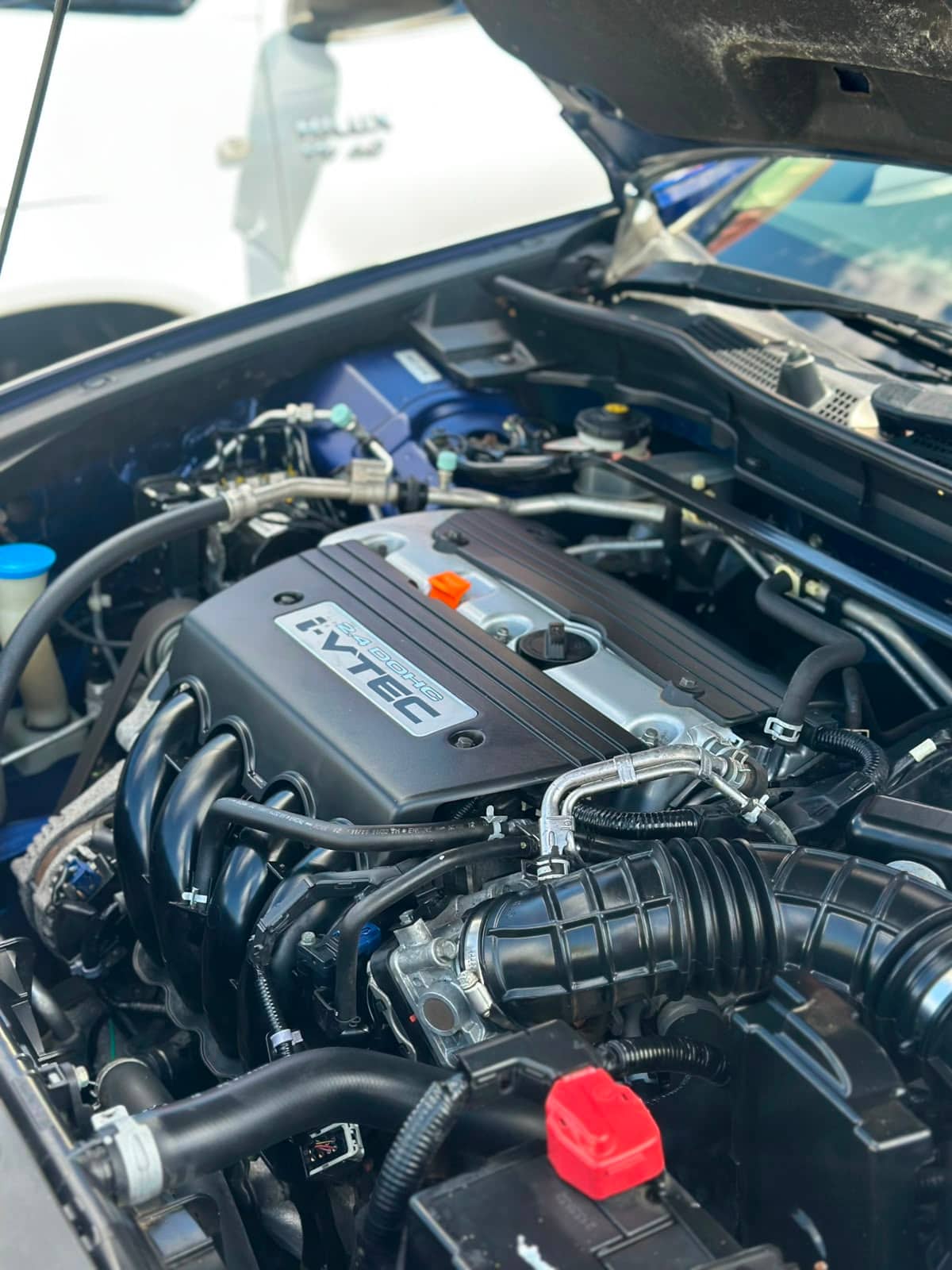 A spotless Honda i-VTEC engine bay with the bonnet up at an inspection