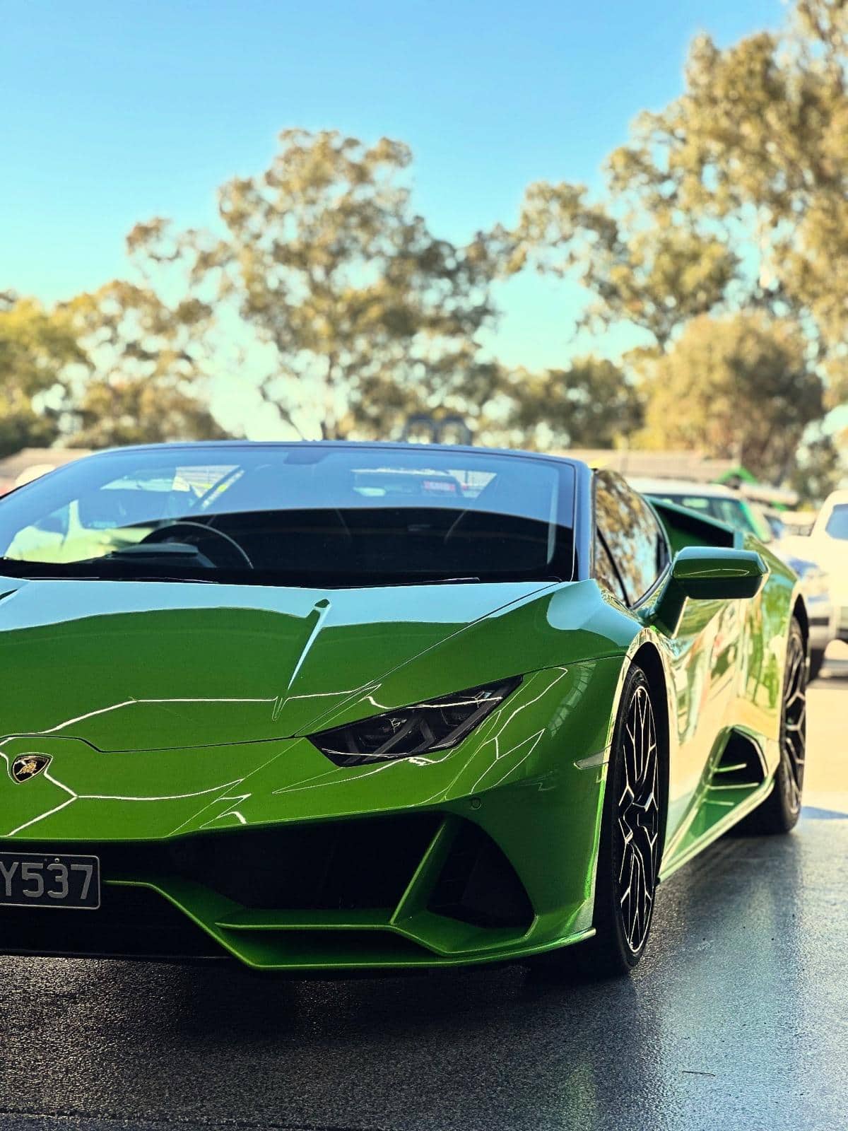 A green Lamborghini Huracan Spyder photographed at an inspection